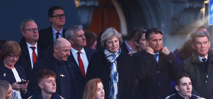 Prime Minister Theresa May watches on