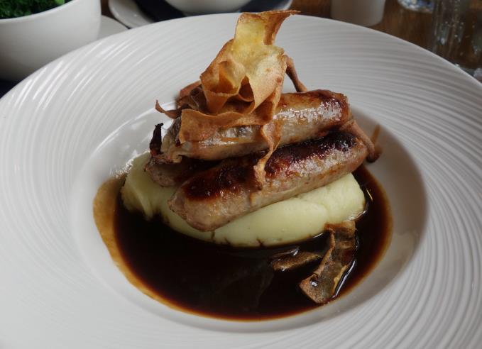 Duck sausages, mash and parsnip chips