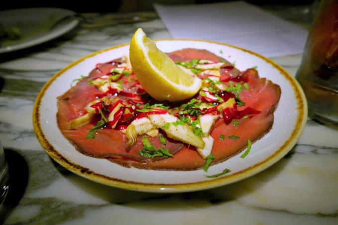 Carpaccio of beef marinated in red wine with artichoke and beetroot dressing 