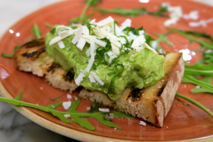 Mashed broad bean, parmesan, mint and basil on grilled bread with matured salted ricotta from Southern Italy