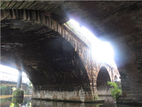 Stuck between later bridges is the Grade 1 listed Liverpool and Manchester Railway viaduct