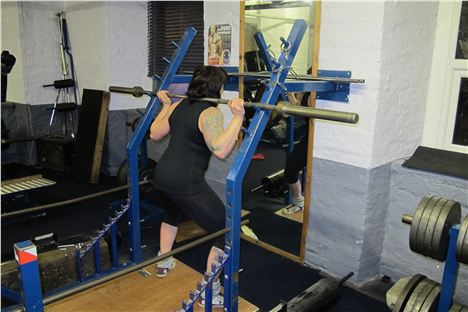 Tania George demonstrates a squat at Olympic Gym in Eccles