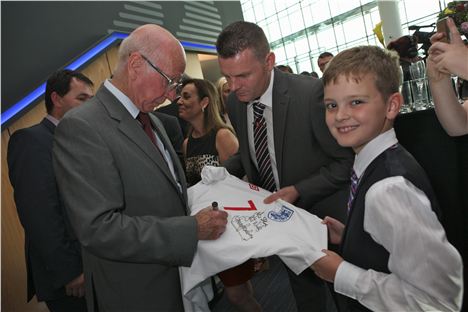 Sir Bobby Charlton signing a shirt