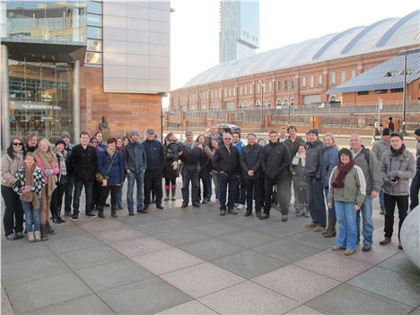 Group about to go down the tunnel with joking man centre carrying frightened woman