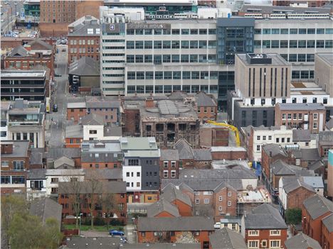 Burnt out building onn Oldham Street being demolised after the recent fire