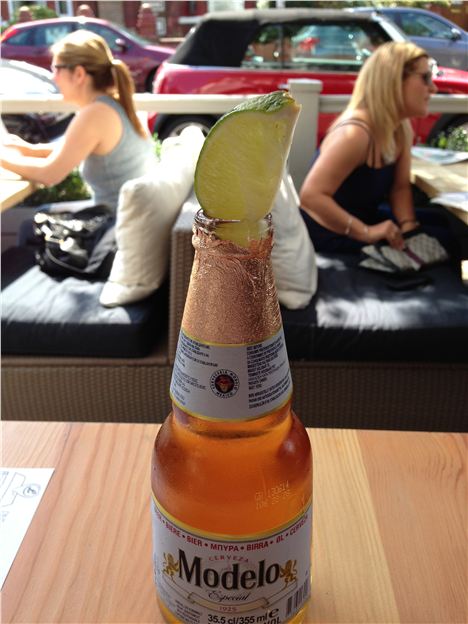 A massive bottle of Modelo and two small bookend women