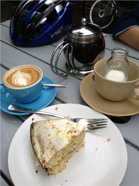 A spread of coffee, cake and tea with the milk in a little bottle