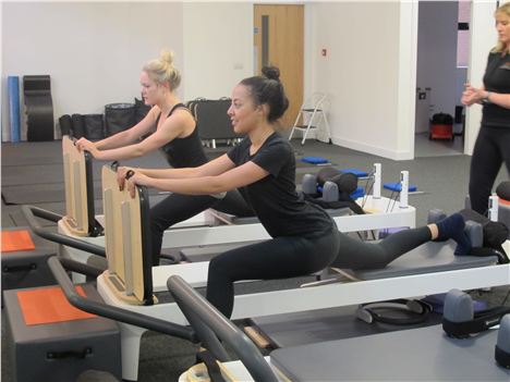 Stretching on the Pilates reformers at The Manchester Pilates Studio