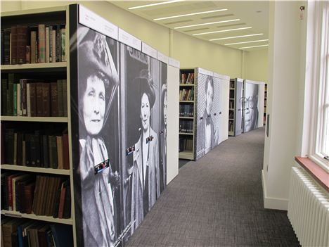 Books, lovely books, behind pictures of people deeply associated with Manchester