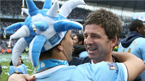 City fan Noel Gallagher celebrates with team