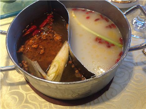 The hotpot bubbling away, spicy on the left the way the locals like it, mild on the right