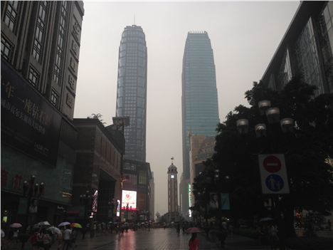 Tiny Liberation Tower with its clock is in the middle of the picture