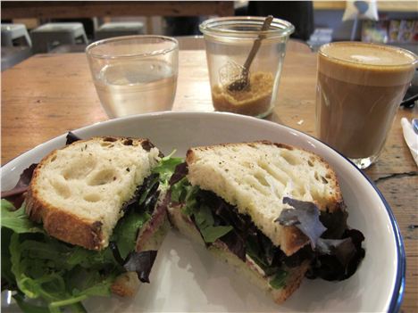 Parma ham, mozzarella, rocket and pesto on Trove bread with the world's smallest flat white coffee