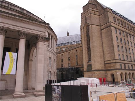 Today's puzzle children is this. In the picture above which is the 'more legible entrance'? Is it a) that big columned thing on the left? Or is it b) that dark glass blob thing between the buildings?