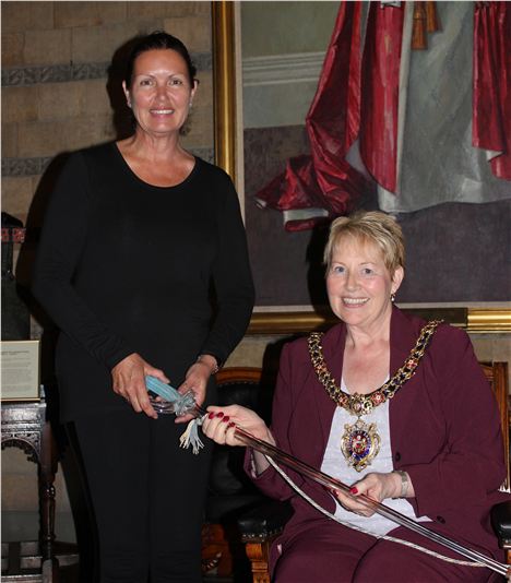 Janette Cox (left) presents Lord Mayor Cooley with the ceremonial glass sword