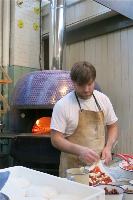 The warm glow of the Honest Crust pizza oven