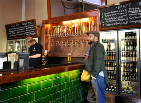 Euston Tap and obligatory beardy flatcap fella