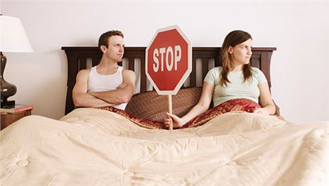 Couple_Holding_Stop_Sign_In_Bed530